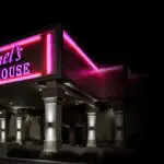 Illuminated restaurant exterior with columns