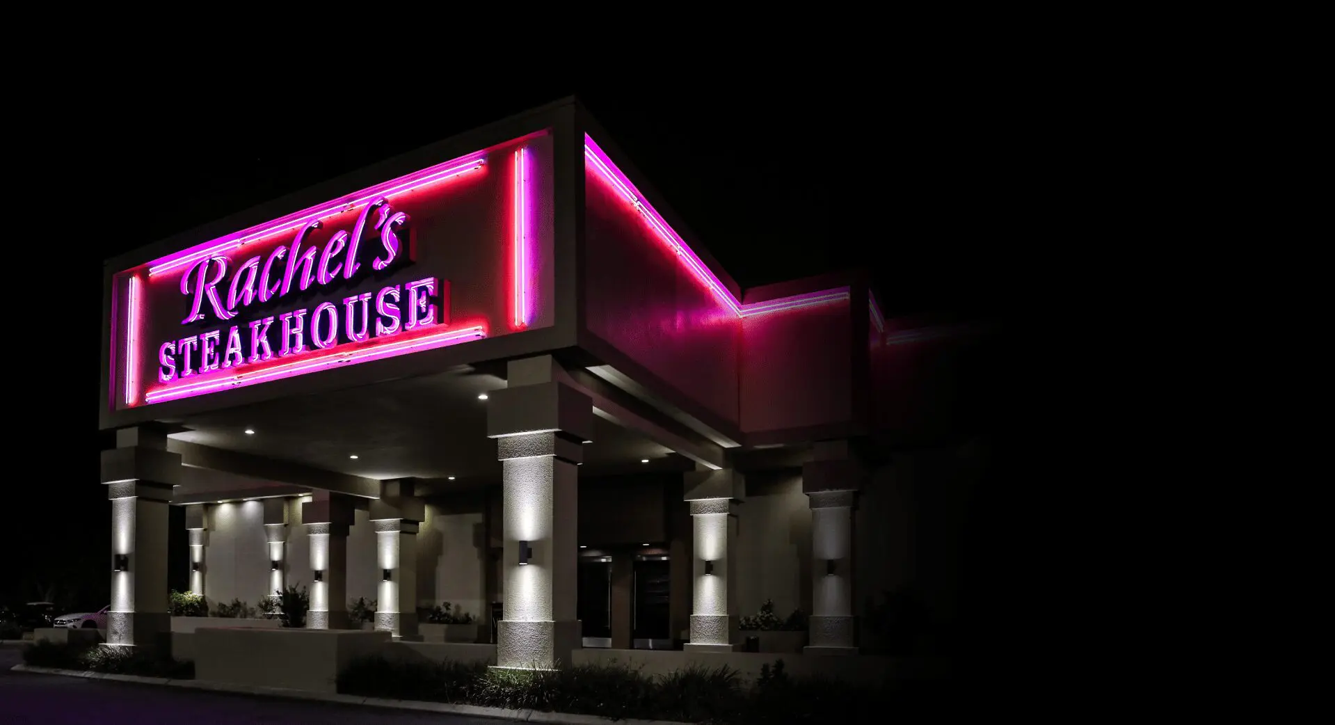 Illuminated restaurant exterior with columns