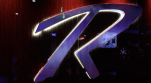 Illuminated logo on dark background