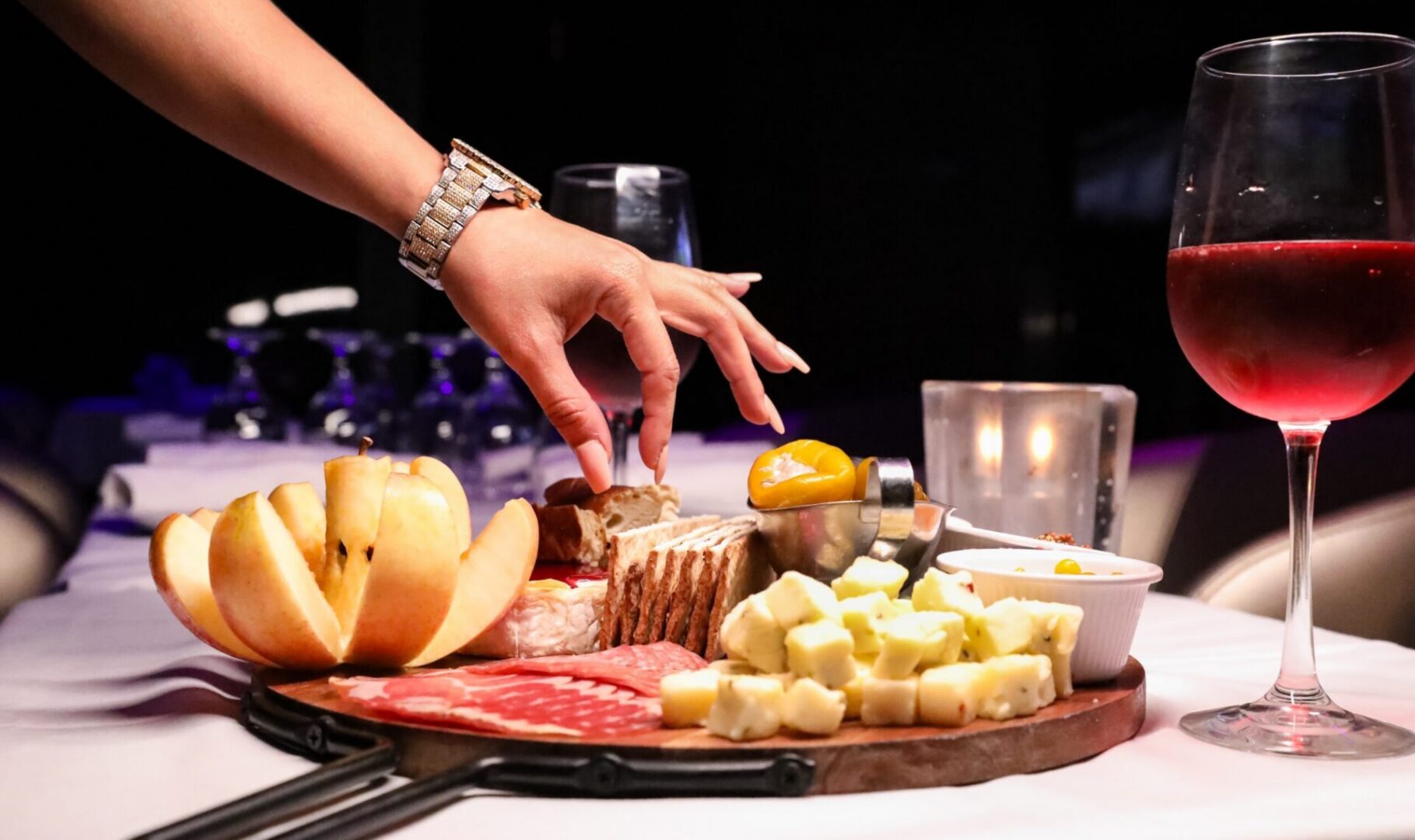 Assorted cheeses and meats on wooden board